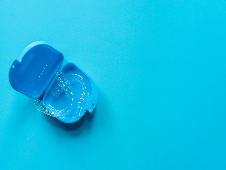 Invisalign clear aligners in a blue case