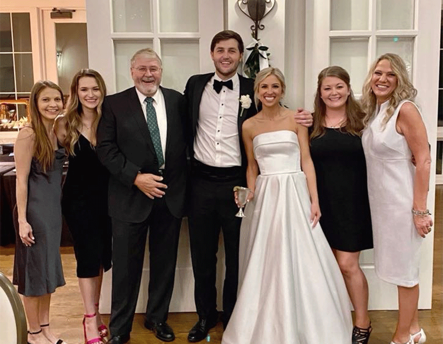 Dr. Collin Myrick standing with his wife and family at his wedding
